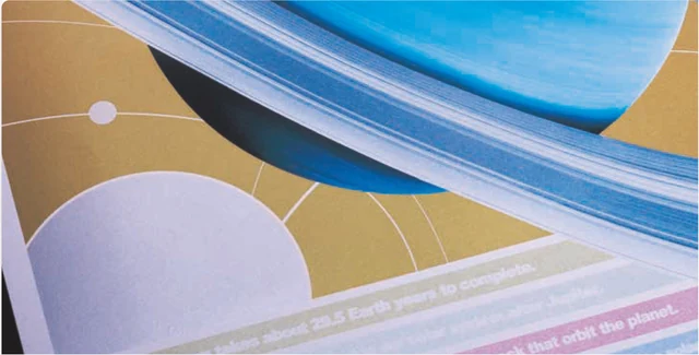 Fujifilm Revoria sample with a metallic gold background behind a blue planetary design